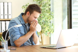 Man sneezing indoors